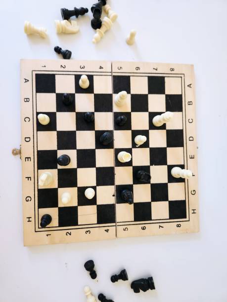 istock chess board game with black and white figures on a white background 1590416399