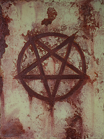 Painting about an inverted pentagram on rusty background