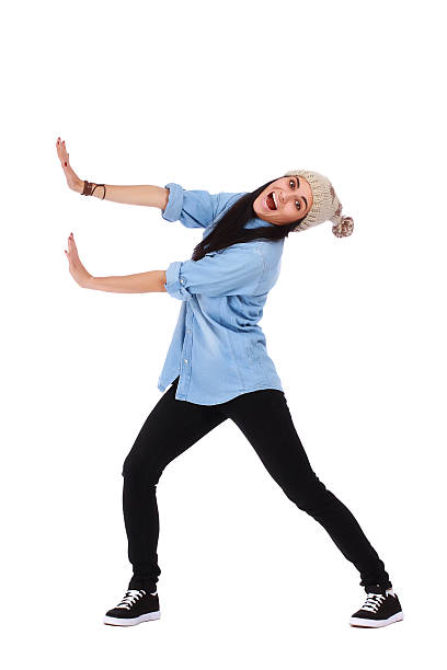 Teenage girl pushing an imaginary object stock photo