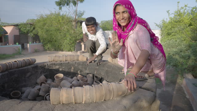 Indian woman working in a pottery workshop, Rajasthan, India