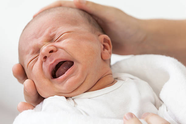 istock Father Parent Holding Crying Screaming Baby 159044036