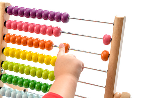 Kid playing with abacus isolated on white background