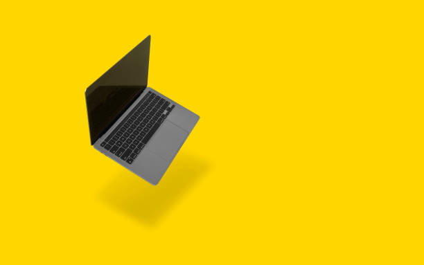 istock Mockup of realistic modern laptop floating on a yellow background 1590531929