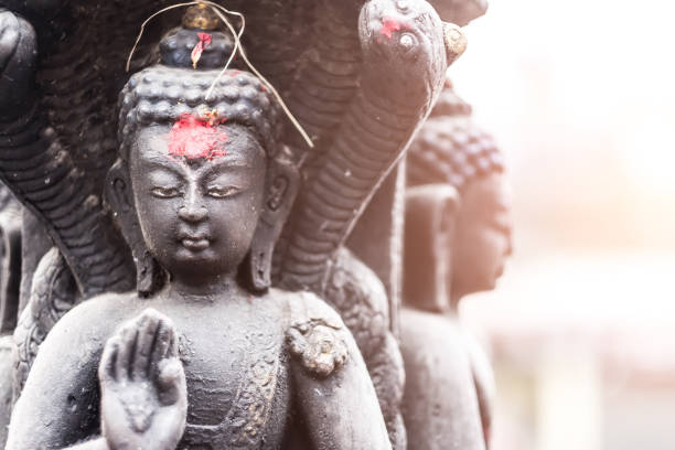 Swayambhunath, Nepal - March 28, 2016: Close-up of buddha in a stone sculpture