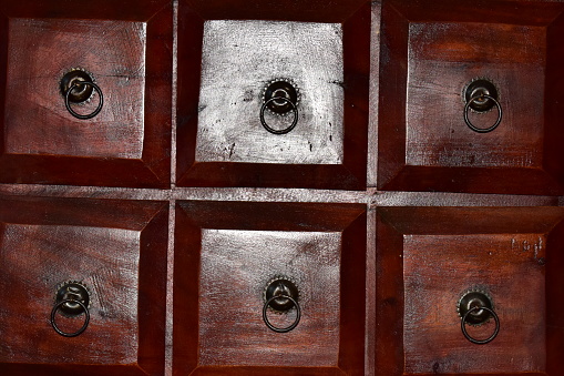 old wooden vintage cabinet with metal doorknobs