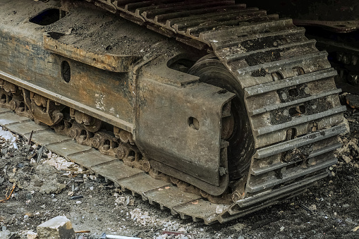 Crawler excavator chassis close up. Tracked chassis with steel wheels.