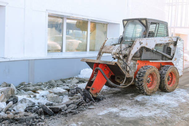 istock Hydraulic jack hammer on a skid steer loader breaker. Hydraulic attachments. 1590576837