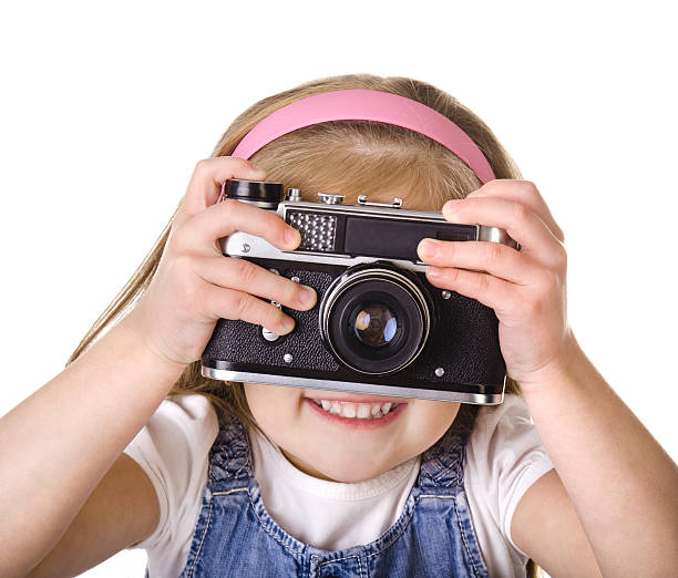 istock Little girl with old camera isolated 159058359