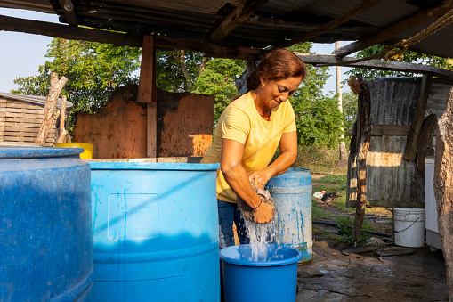 Family woman washing clothes in jars