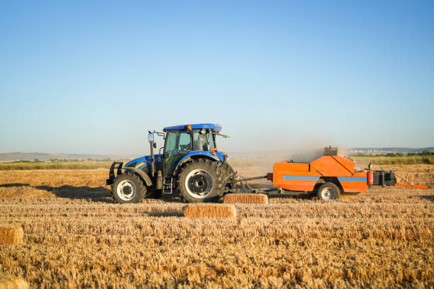 istock man making bales with tractor and machine in big field at sunset 1590589604