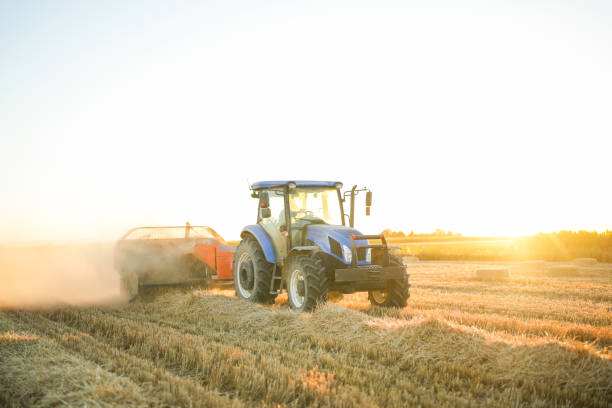 istock man making bales with tractor and machine in big field at sunset 1590596062