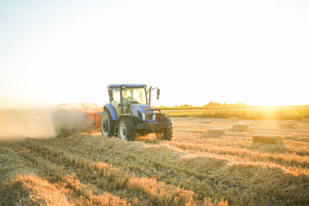 istock man making bales with tractor and machine in big field at sunset 1590598148