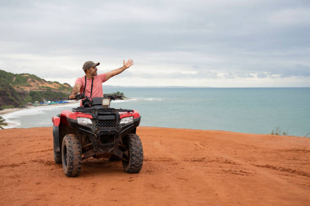 istock Tourist using four wheel motorcycle at the beach 1590633030