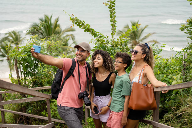 istock Beautiful family making selfie on the beach 1590633599