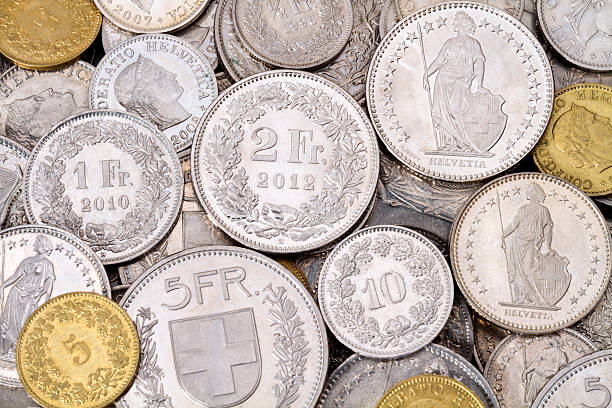 Pile of Modern Swiss Franc Coins A pile of current, legal tender Swiss Francs (CHF) coins. All current Swiss coin denominations are represented in this image. swiss coin stock pictures, royalty-free photos & images