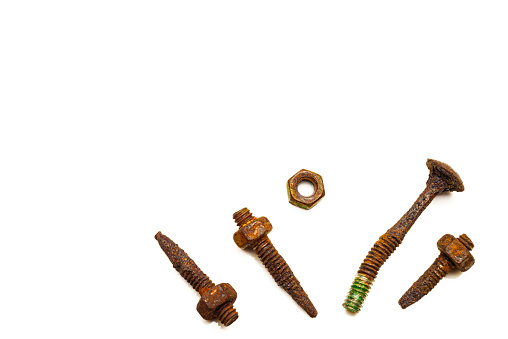 Detail of rusty oxide nut and bolts on white background