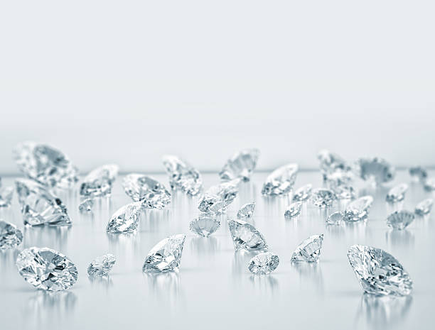 Scattered group of various sized diamonds stock photo