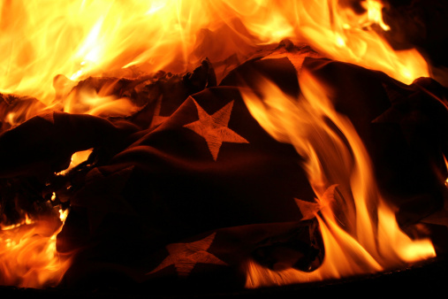 A United States of America Flag is retired properly and respectfully by burning during a flag retirement ceremony.