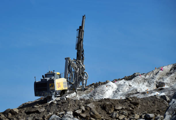 Nuuk / Godthåb, Sermersooq, Greenland: drilling rig at work on a rocky slope - tophammer drilling, surface drill rig for quarrying and construction - (Epiroc Smartroc T40, operated by Munck civil engineering)