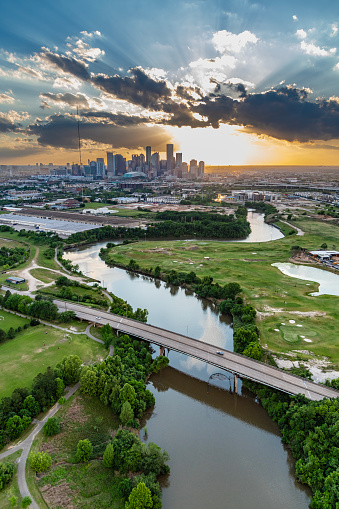 The Buffalo Bayou winding its way toward downtown Houston, Texas at sunset shot from over the East End neighborhood.