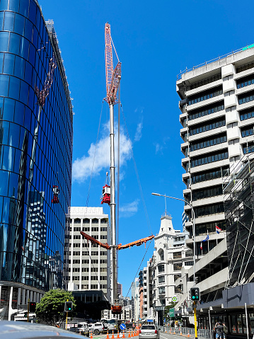 Wellington, New Zealand - January 14, 2023: Giant's reach, capturing the crane installation on Featherston St