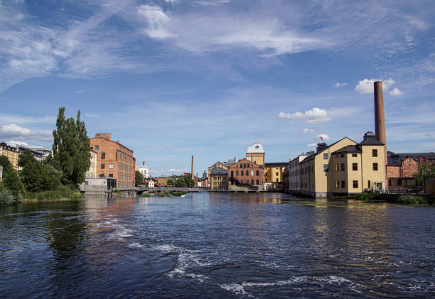 istock View of buildings by river against cloudy sky 1590767682