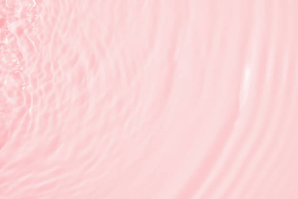 istock Abstract transparent water shadow surface texture natural ripple on pink background 1590818295