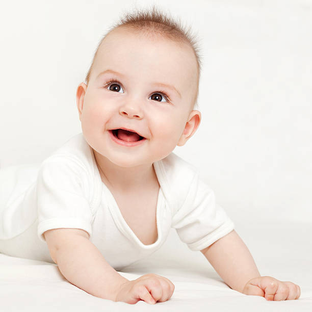 istock A cute happy baby laying on a white background 159082244