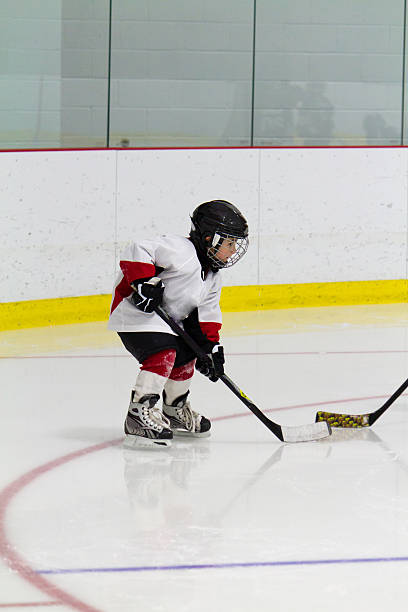 istock Little boy playing ice hockey 159084485
