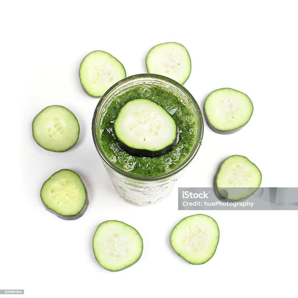 Cucumber smoothie. Cucumber Smoothies surrounded by sliced cucumbers isolated on white. Blended Drink Stock Photo