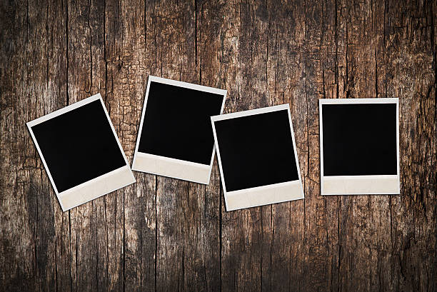 istock Empty instant photos on old wooden texture 159088824