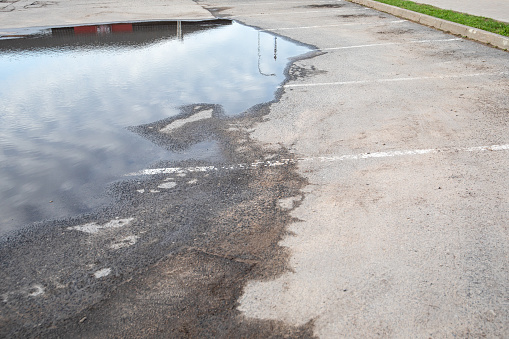 Parking lot under water. Weather conditions and sewage system.