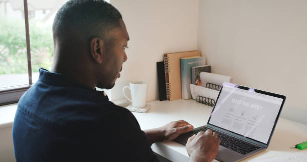 istock Remote work, laptop and black man typing proposal in home office, email or networking online. Technology, communication and freelancer with computer at desk in apartment on research project pitch. 1590917920