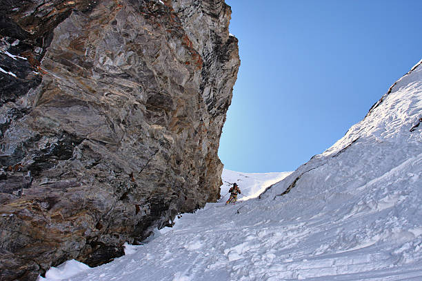 istock Skier on a steep slope near the overhanging rock 159096780