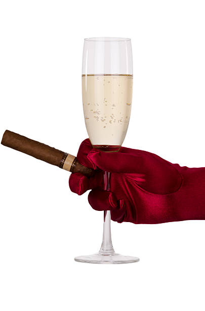 Celebration Hand in red glove holding flute of champagne and cigar, over white background. smoking women luxury cigar stock pictures, royalty-free photos & images
