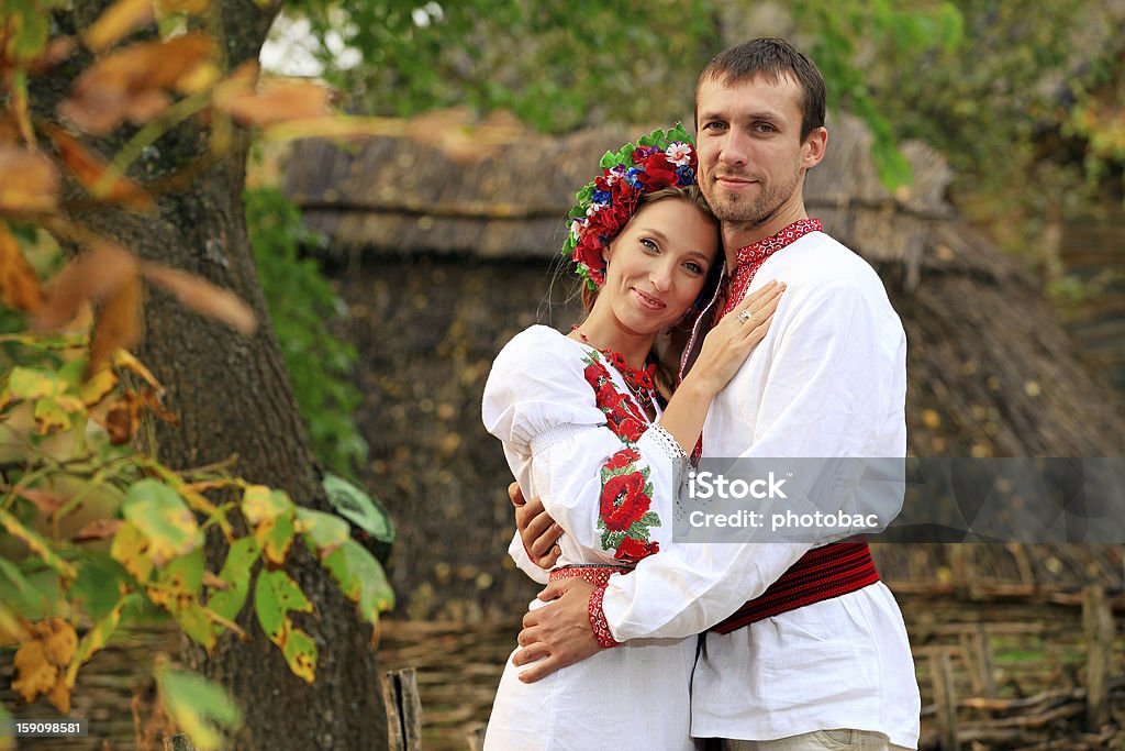 Lovely couple in Ukrainian national costumes outdoors Portait of a lovely couple in Ukrainian national costumes outdoors Adult Stock Photo