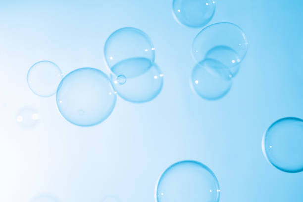 istock Beautiful Transparent Blue Soap Bubbles Floating in The Air. White Space, Abstract Fun Background, Blue Gradient Blurred Background, Refreshing of Soap Suds Bubbles Water. 1591026175
