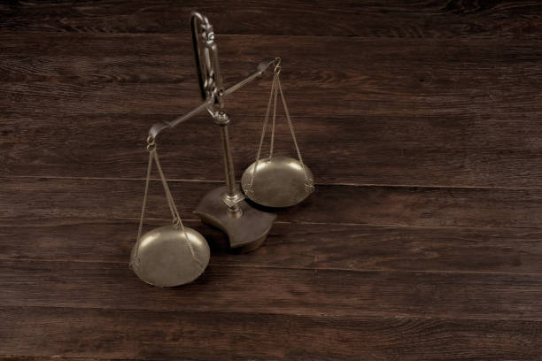istock Bronze traditional balance scale on wooden table 1591050950