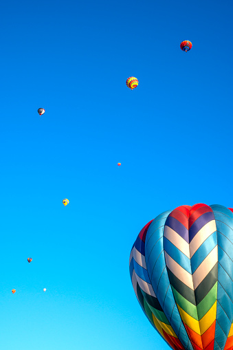 Colorful hot air balloons against blue sky, Balloon Festival. Space for text
