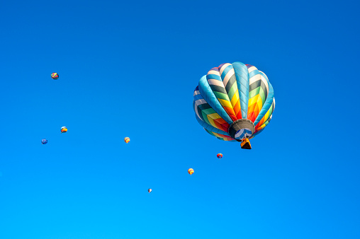 istock Colorful hot air balloons and bright blue sky, close up view, selective focus. Space for text 1591065932