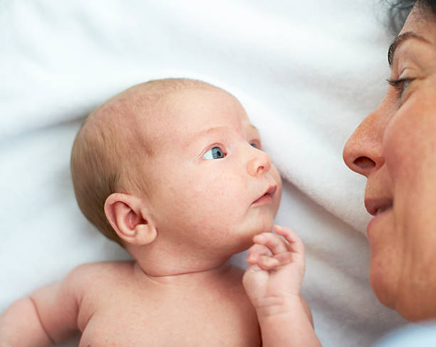 mother and newborn baby newborn baby and mother looking at one another mom and baby eye contact stock pictures, royalty-free photos & images
