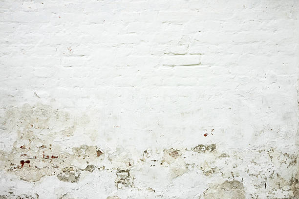 Cracked white brick wall stock photo