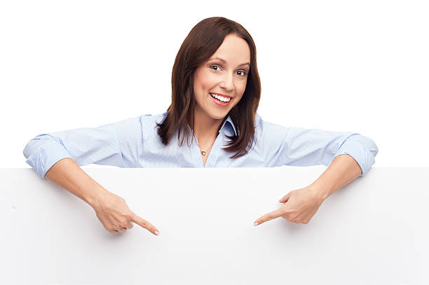 istock Woman pointing at blank board 159115683