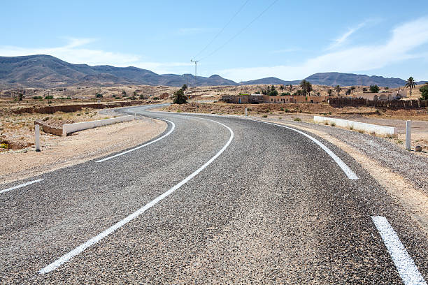 istock Asphalt way with white road marking in mountain terrain 159117220