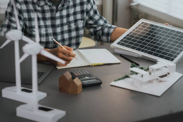 istock Engineers calculate the design of renewable energy, both wind and solar. selective focus, design concept of renewable energy, solar energy utilization, calculation, design solar installation system 1591190187