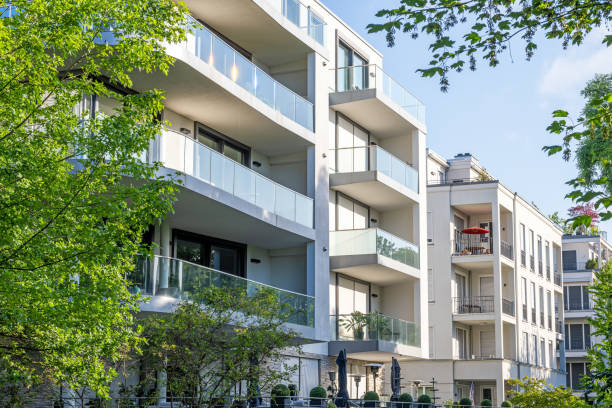 istock Modern apartment buildings surrounded by greens 1591208283