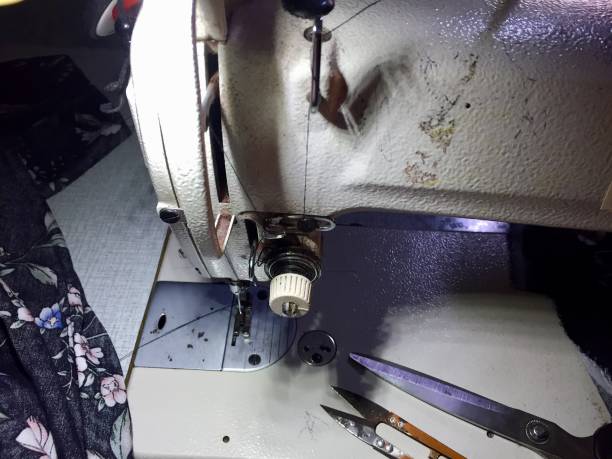 istock scissors, machine and fabric to be sewn 1591211137
