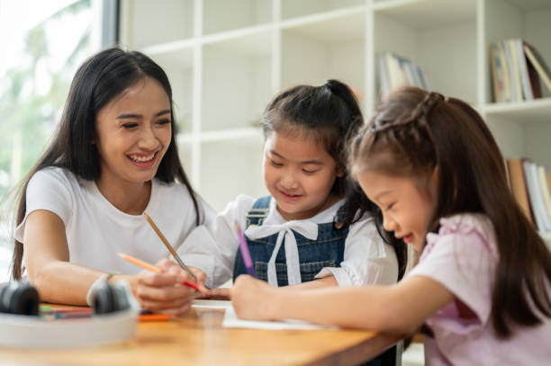 istock A kind Asian female private tutor is teaching young students at home. kindergarten 1591211649