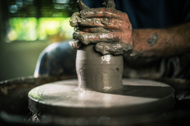 shoot of an unrecognisable man working with clay in a pottery studio shoot of an unrecognisable man working with clay in a pottery studio pottery making stock pictures, royalty-free photos & images