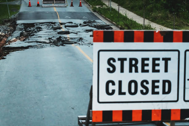 Suburban road washed out by flash flooding from record-breaking rainfall.